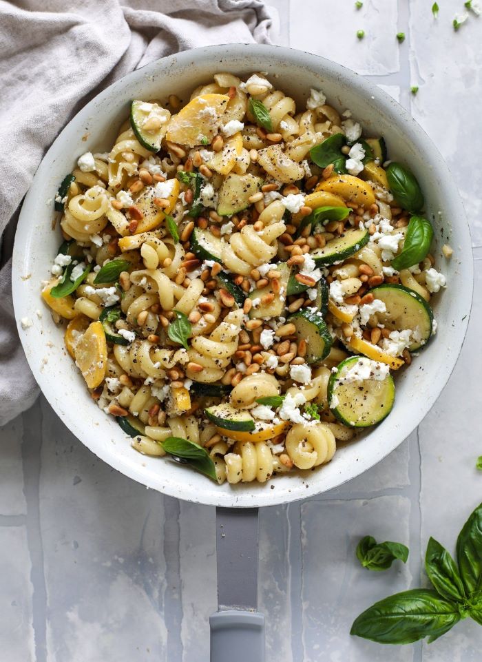 zuchhini and squash pasta how to cook yellow squash garnished with crumbled feta basil leaves cedar nuts