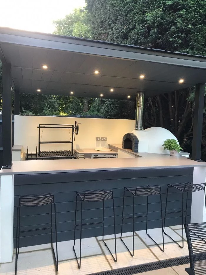black wooden kitchen island with white countertop diy outdoor bar black metal stools pizza oven