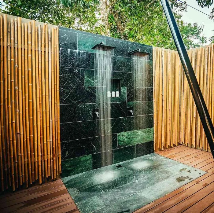 blue and green turquoise marble tiles on the wall and floor outdoor shower designs bamboo sticks on the walls