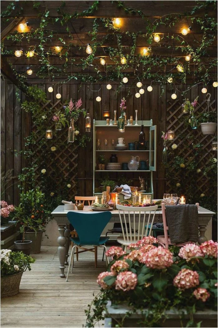 blue white and pink chairs around dining table outdoor hanging lights strings of lights hanging from the ceiling