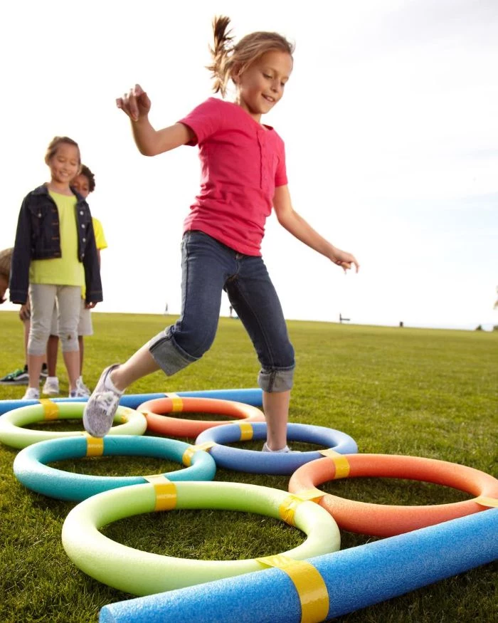 circles made with pool noodles fun things to do outside girls jumping into the circles