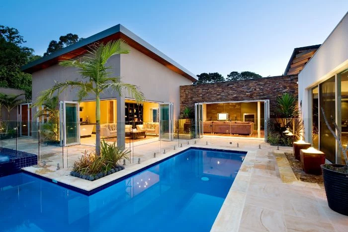 contemporary house with small l shaped pool inground pool design palm trees around it