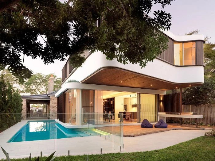 contemporary two storey house small backyard pools two bean bag chairs on the side of pool