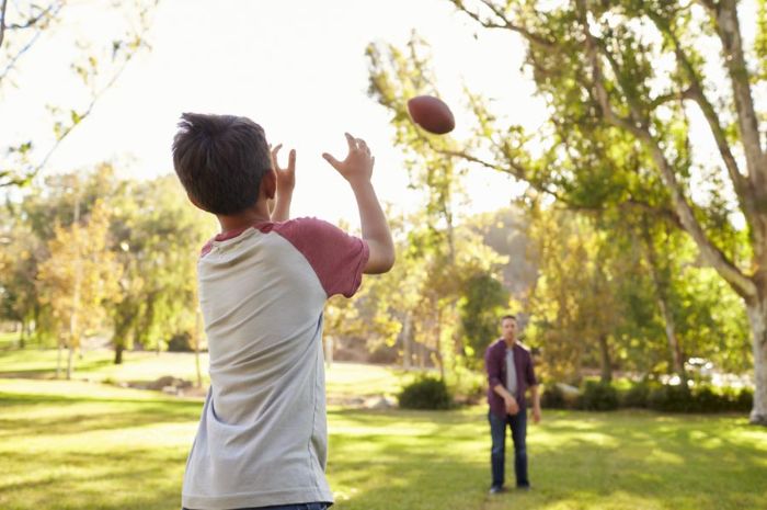 dad and boy playing catch outdoor activities for toddlers dad throwing the ball at the boy