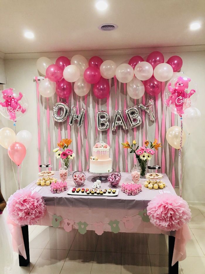 dessert table with cake cupcakes flower bouquets baby shower decorations pink and white baloons oh baby garland balloons