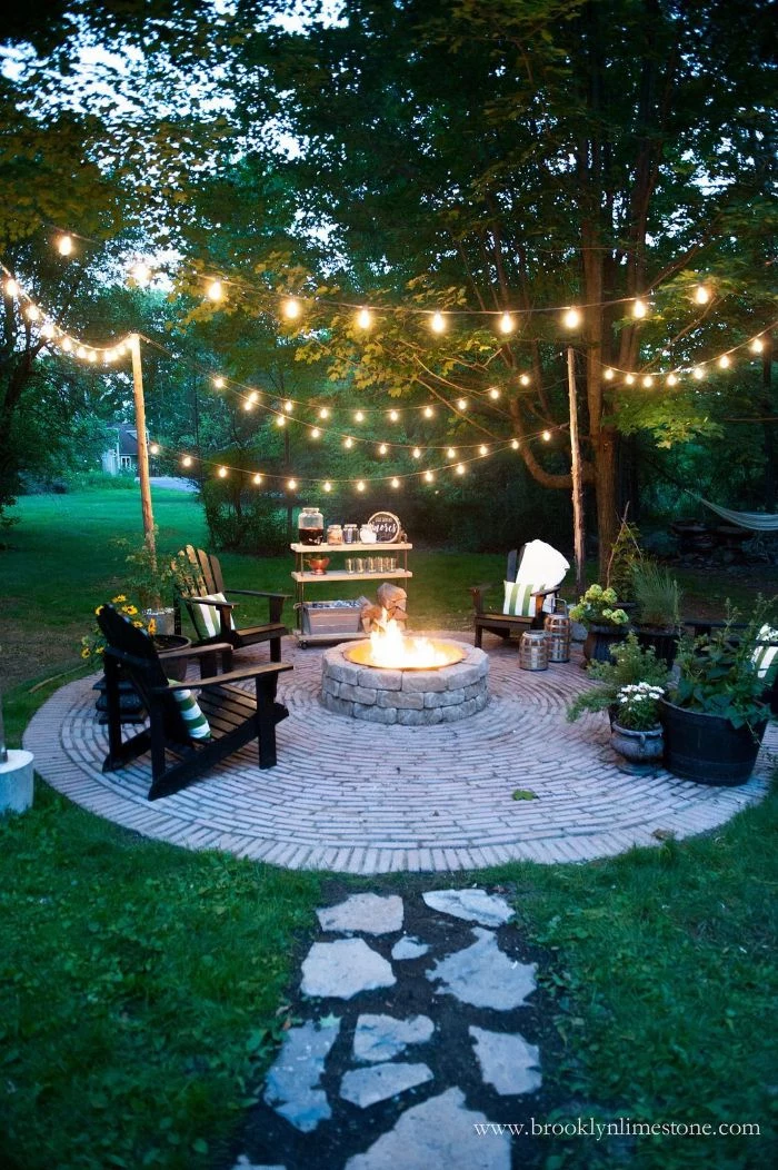 fire pit lounge are and bar table around it outdoor lighting ideas strings of lights hanging from the trees above it