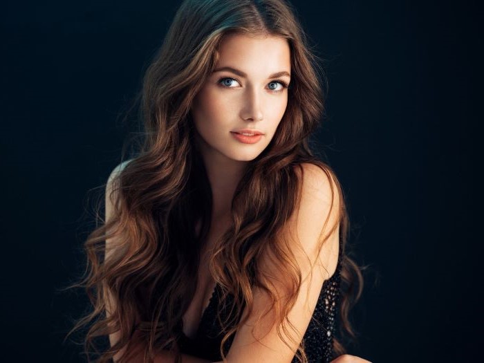 girl with blue eyes most iconic looks long brown hair with beach waves center part