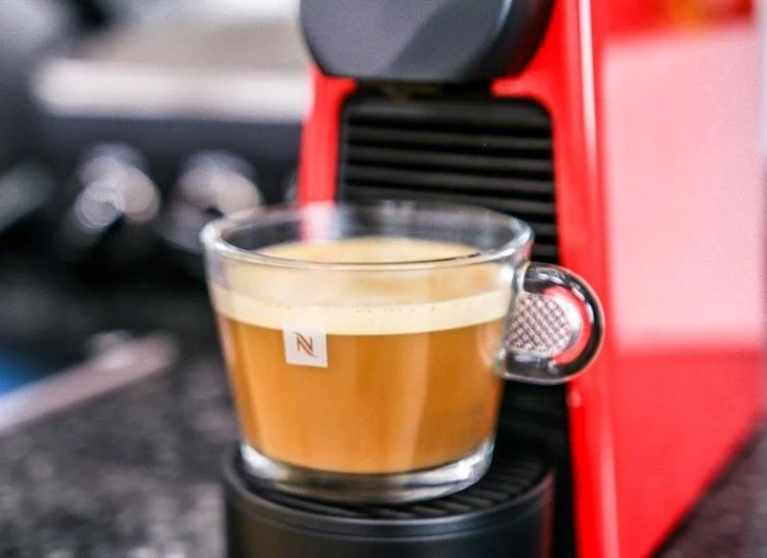 glass coffee cup placed on espresso machine coffee to water ratio filled with coffee