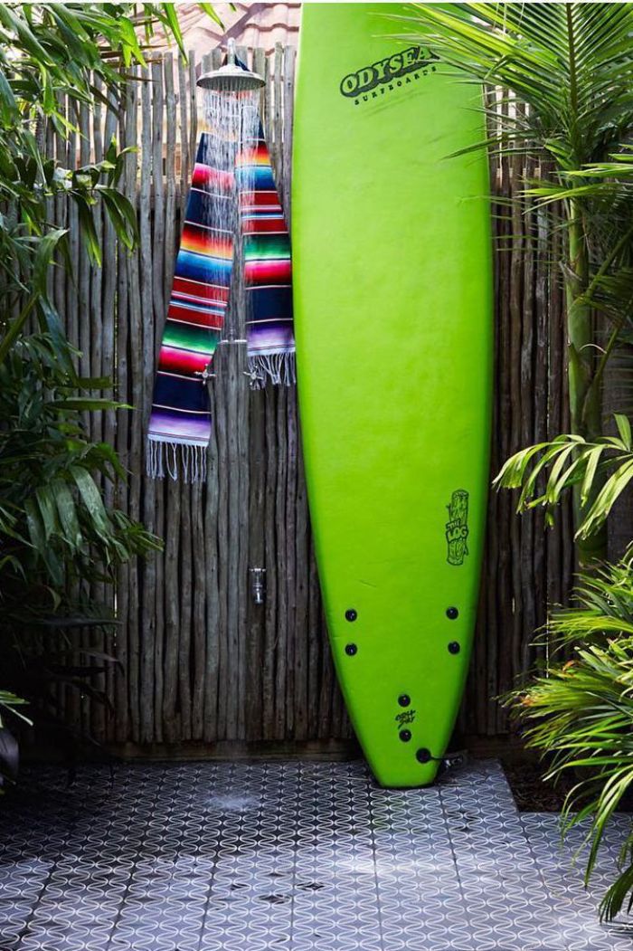 green surf on the side diy outdoor shower wall made of bamboo with colorful scarf hanging on the shower head