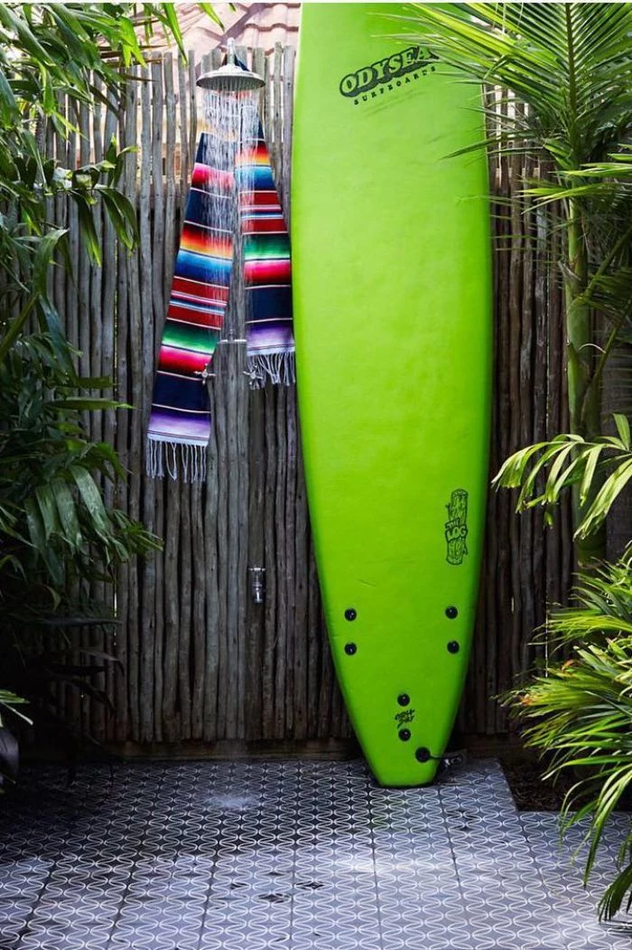 green surf on the side diy outdoor shower wall made of bamboo with colorful scarf hanging on the shower head