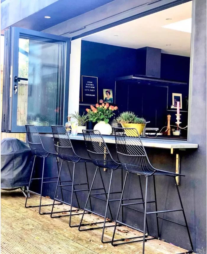 home bar ideas on a budget black metal stools next to open windows looking into kitchen