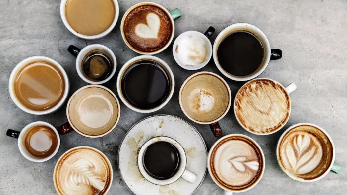 lots of coffee cups and mugs some with black coffee how to make coffee others with milk foam