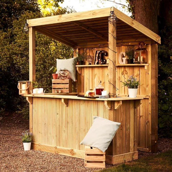 mini bar inside wooden enclosure how to build an outdoor bar decorated with lanterns crates throw pillows