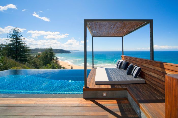 modern pool designs infinity pool with wooden deck and lounge area sea view