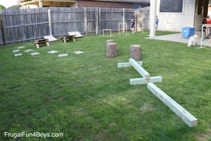 ninja warrior obstacle course build in the backyard with wooden logs and pallets outdoor fun for kids