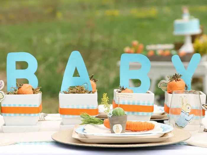orange and blue ribbons over centerpieces spelling baby baby shower party favors peter rabbit theme