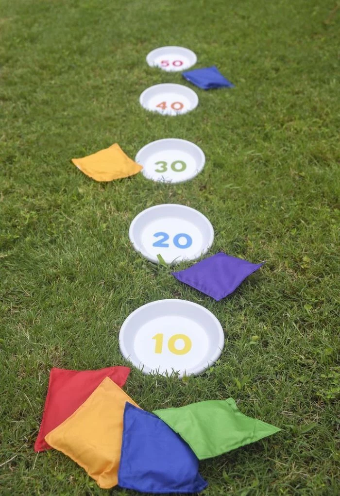 outdoor activities for kids white plates with different numbers in them for points corn bags thrown at them