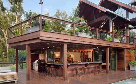 outdoor bar ideas bar below the deck of two storey house with black metal stools around it