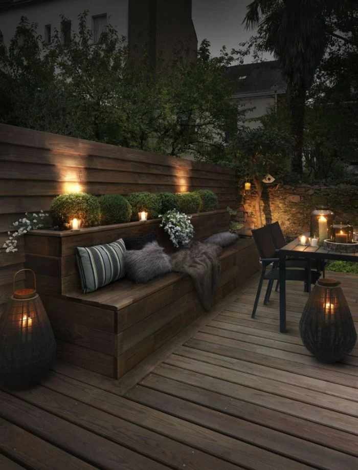 outdoor lighting ideas lanterns and candles placed on the floor and table lamps between the bushes