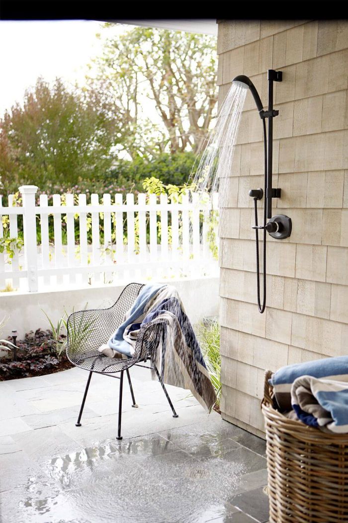 outdoor shower designs black shower mounted on tiled wall tiled floor metal chair next to it