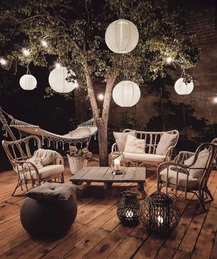 paper lanterns hanging from a tree how to hang outdoor string lights lounge area with garden furniture underneath