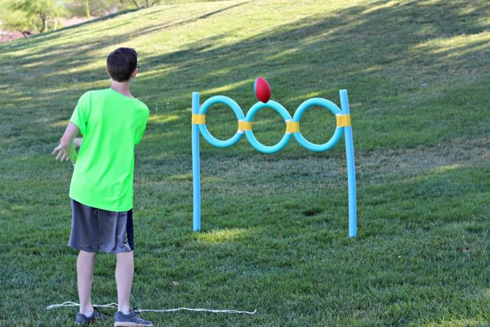 pool noodles turned into hoops games to play outside boy shooting a ball inside the hoops