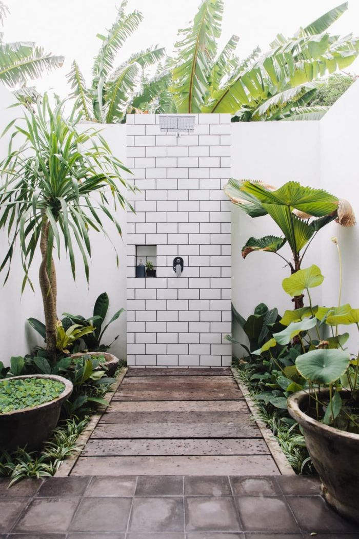 subway tiles on shower wall wood floor building an outdoor shower surrounded by palm trees and plants