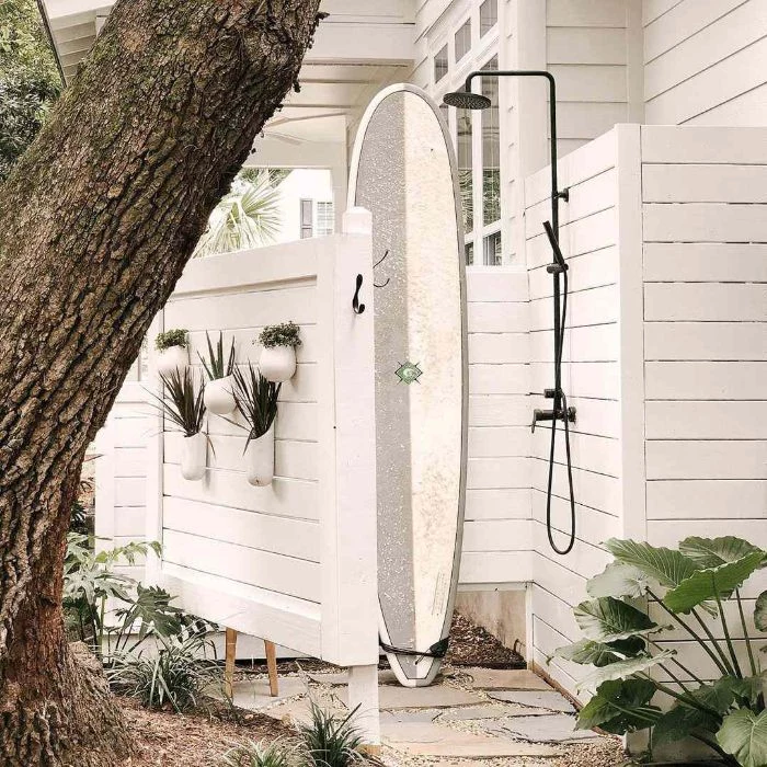 surf leaning on white wood enclosure how to build an outdoor shower black metal shower head pipes and faucet