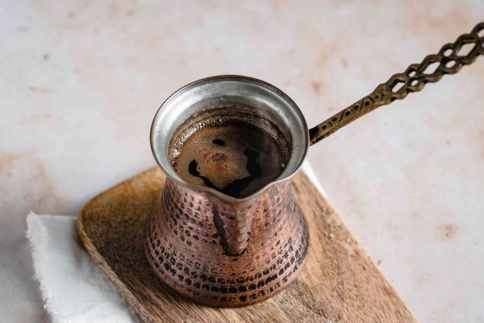 turkish coffee recipe how to make coffee in a pot placed on small wooden chopping board