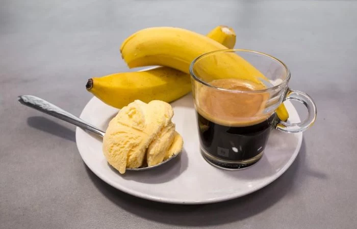 two bananas ice cream in a spoon coffee in mug how to make cold brew coffee placed on plate