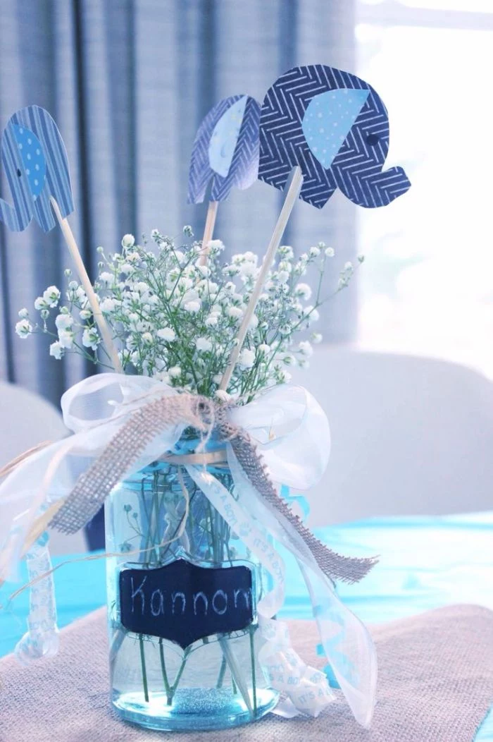 white ribbon and burlap wrapped around jar baby shower decorations girl filled with babys breath flowers