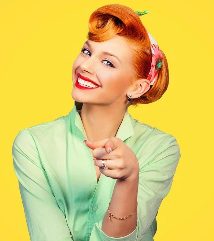 woman with red hair 1950s hairstyle most iconic looks wearing green shirt