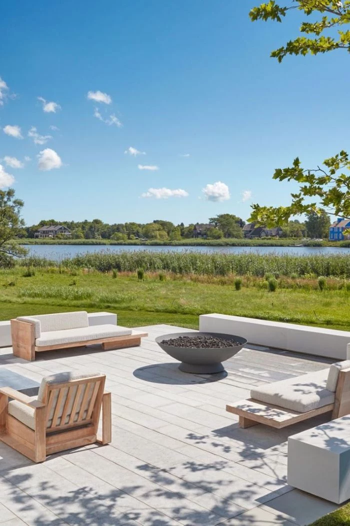 bench and wooden furniture with white cushions homemade fire pit metal bowl filled with rocks