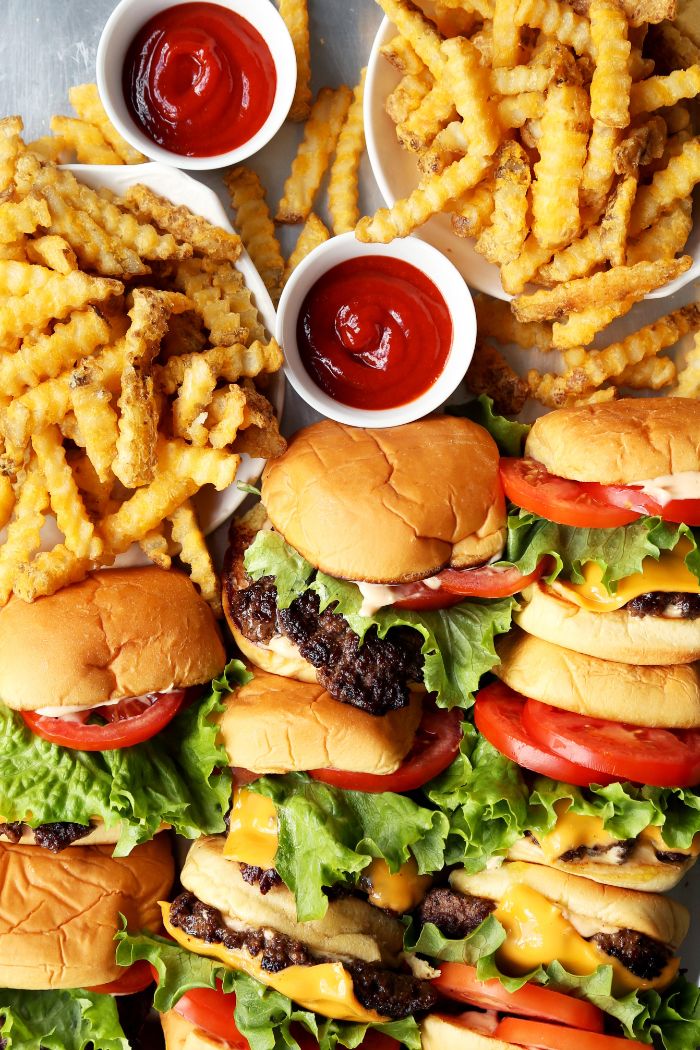 best burger recipe lots of burgers arranged on platter with french fries ketchup