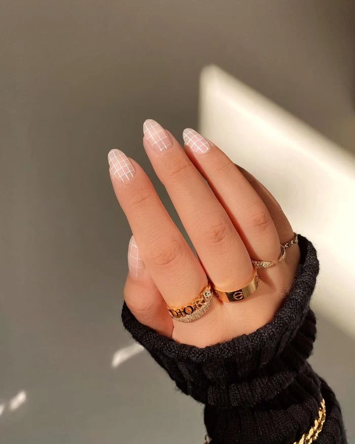 black sweater with gold jewelry nail designs 2021 nude nail polish with white lines decorations
