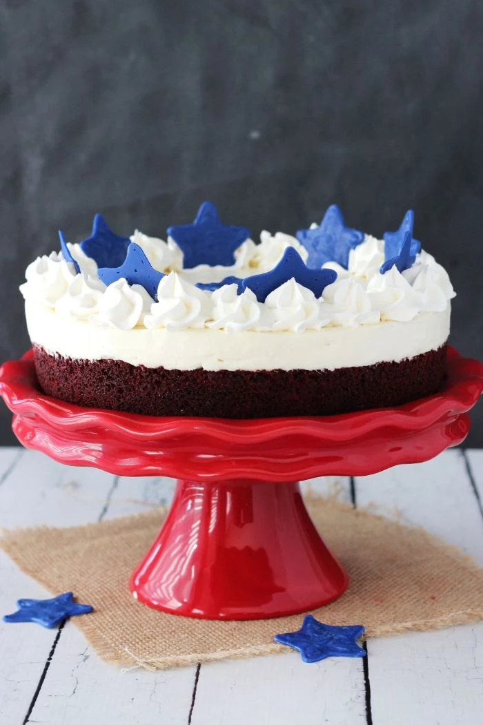 blondie cheesecake placed on red cake stand 4th of july desserts decorated with blue stars