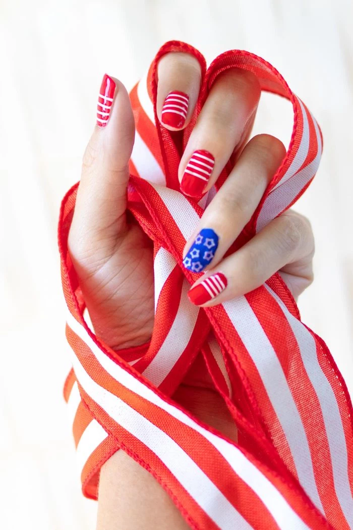 blue and red nail polish on medium length squoval nails 4th of july nail designs stripes and stars decorations