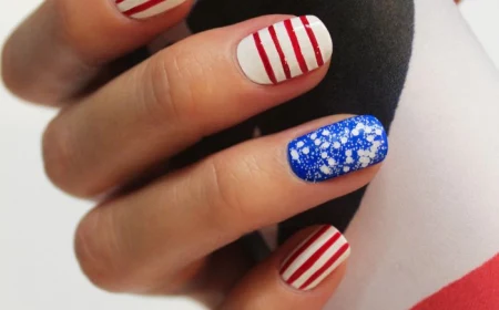 blue glitter white nail polish patriotic nails red stripes in different directions drawn on short squoval nails