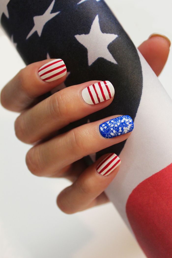 blue glitter white nail polish patriotic nails red stripes in different directions drawn on short squoval nails