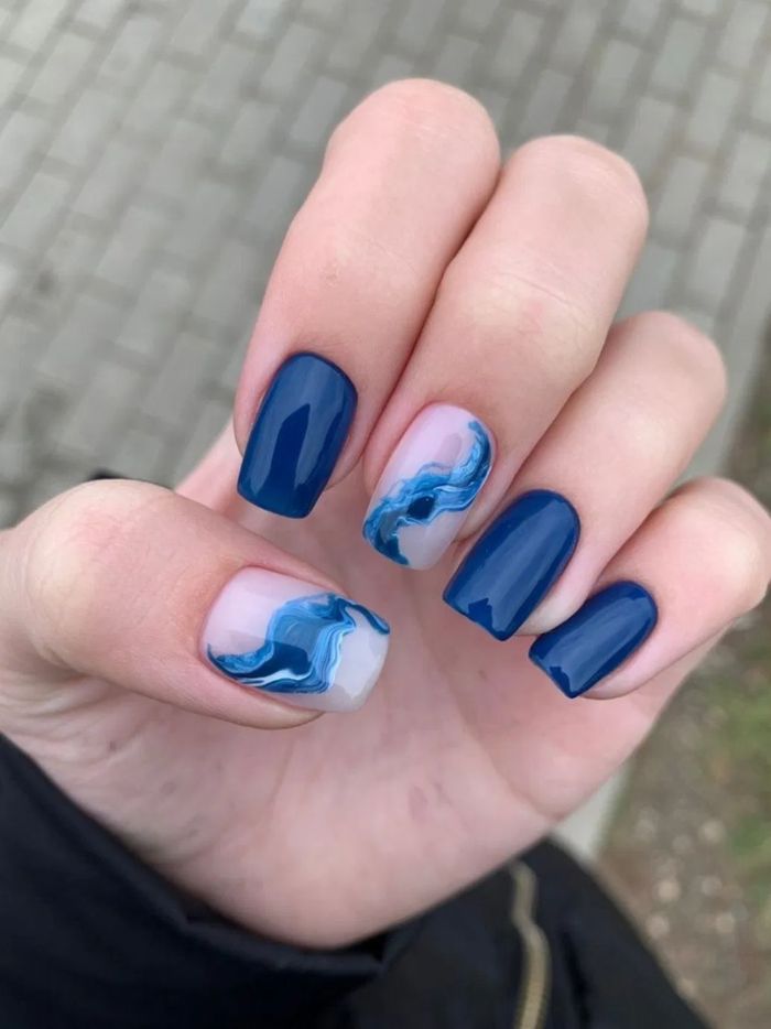 blue nail polish on medium length square nails summer nail colors blue marble decoration on middle finger and thumb