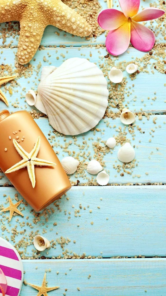 blue wooden surface summer wallpaper hd seashells and sunscreen beach sand on it