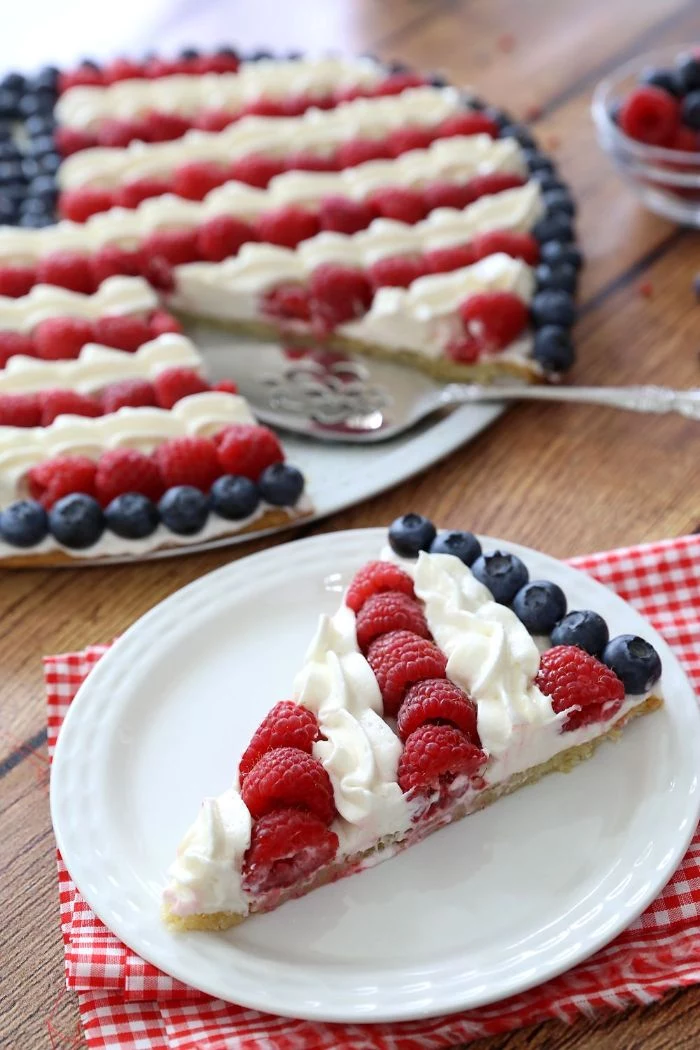 cheesecake decorated with cream blueberries and raspberries as the american flag 4th of july recipes
