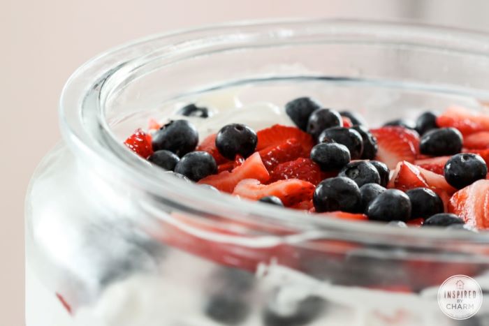 close up photo of top of trifle traditional 4th of july foods decorated with blueberries strawberries