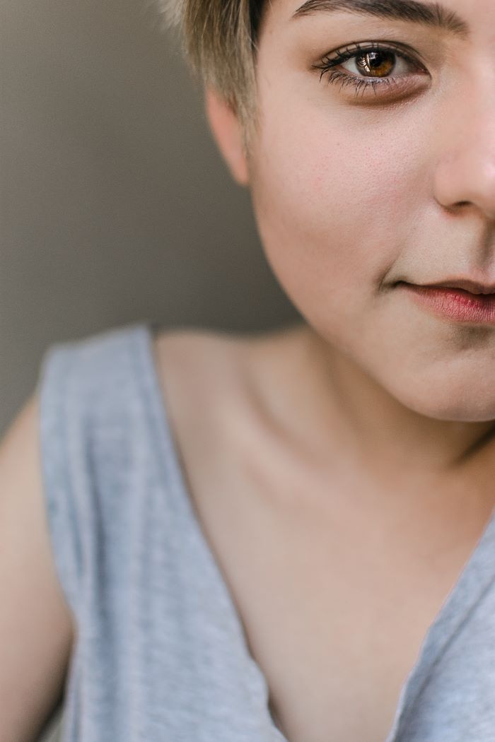 close up photo of woman with short blonde hair wearing gray top discovering you skin type