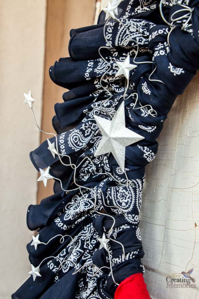 close up photo of wreath made with bandanas 4th of july banner silver stars