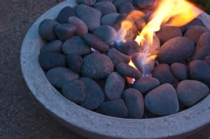 concrete bowl filled with rocks step by step diy tutorial backyard fire pit ideas landscaping fire burning inside