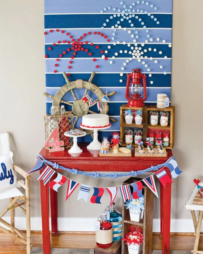 desserts table painted in red with cake cupcakes on it patriotic decorations fireworks background