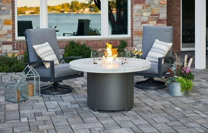 diy fire pit ideas two lounge chairs with gray cushions next to round fire pit two wine glasses on top