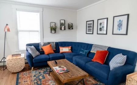 décor ideas for living room large blue corner sofa orange throw pillows art work on the walls
