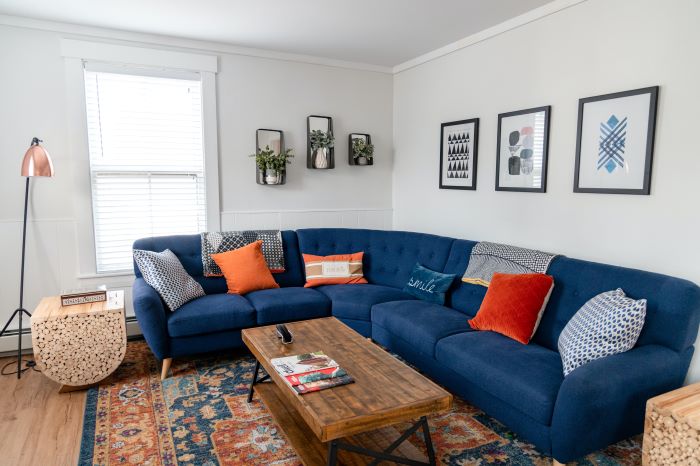 décor ideas for living room large blue corner sofa orange throw pillows art work on the walls